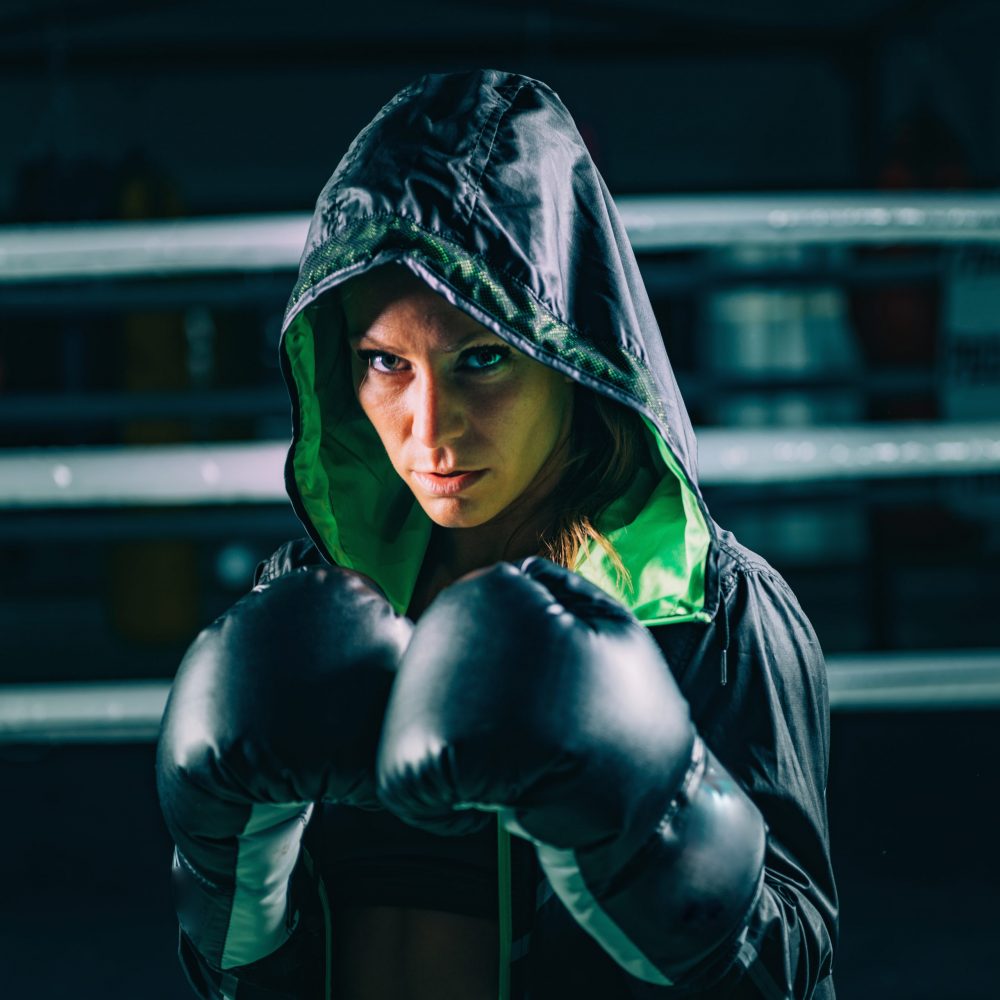 Portrait of female boxer Portrait of female boxer with boxing gloves and hoodies